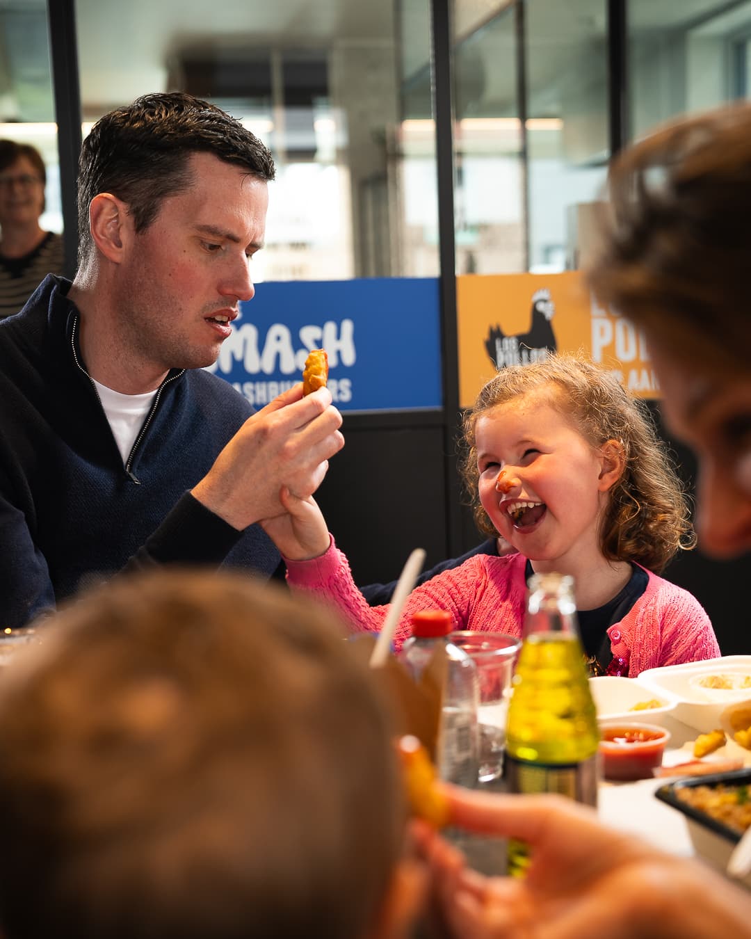 Father and daughter enjoying a meal together